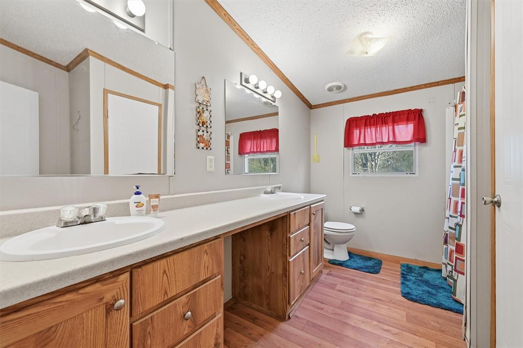 227 Sheryl Lane Denison, TX 75021 - Photo 22 of 37 a bathroom with a sink a vanity and a mirror