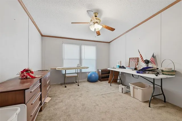 a workspace with furniture and ceiling fan