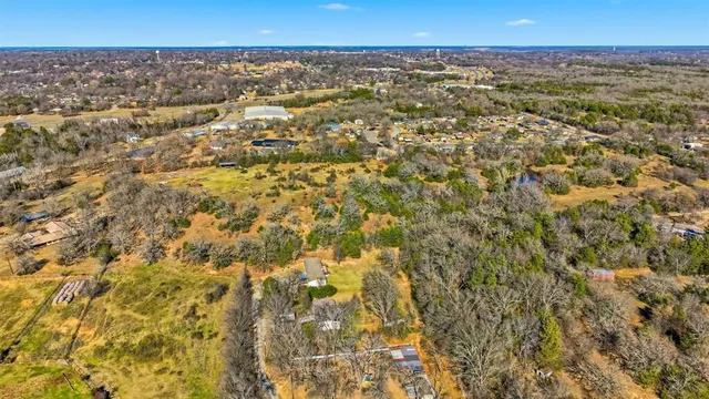 an aerial view of residential houses with city view