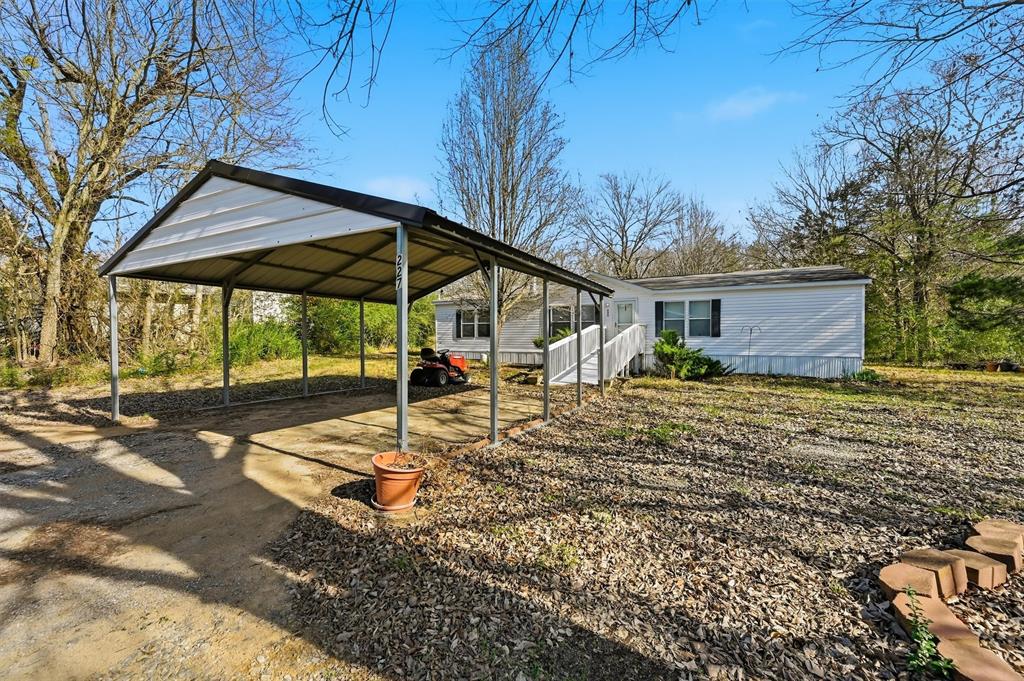 227 Sheryl Lane Denison, TX 75021 - Photo 37 of 37 a backyard of a house with table and chairs