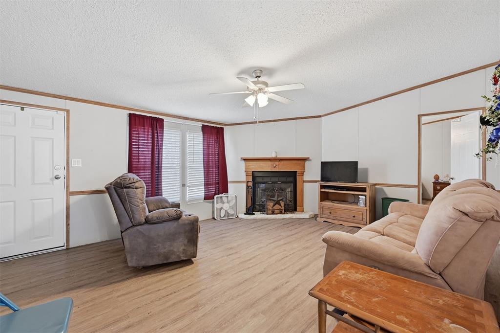 227 Sheryl Lane Denison, TX 75021 - Photo 6 of 37 a living room with furniture a fireplace and a flat screen tv