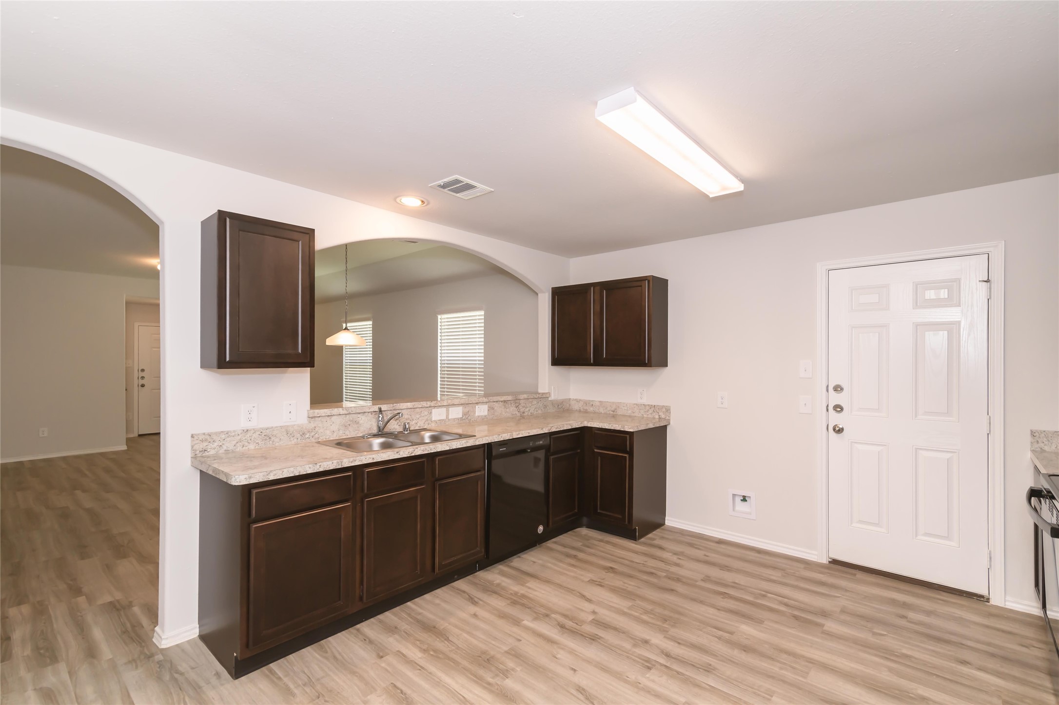a spacious bathroom with a granite countertop double vanity sink and mirror