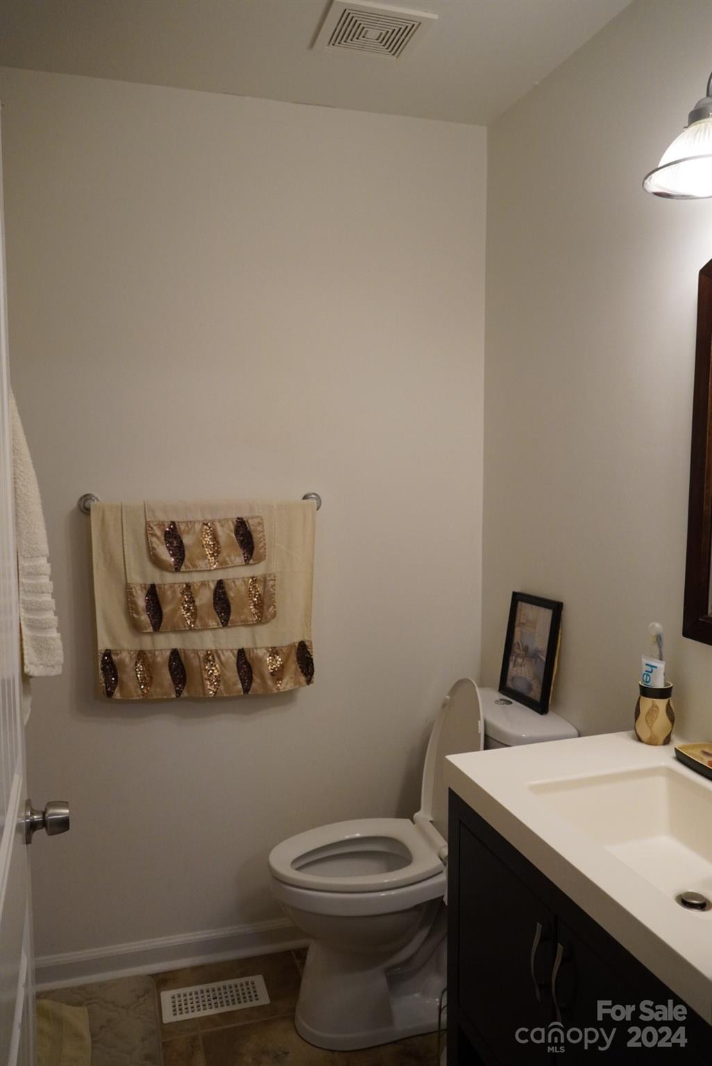 8357 Barncliff Road Charlotte, NC 28227 - Photo 7 of 15 a bathroom with a sink and toilet