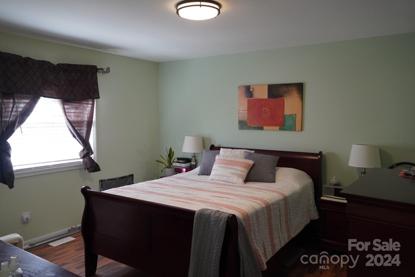 8357 Barncliff Road Charlotte, NC 28227 - Photo 8 of 15 a bedroom with bed and window