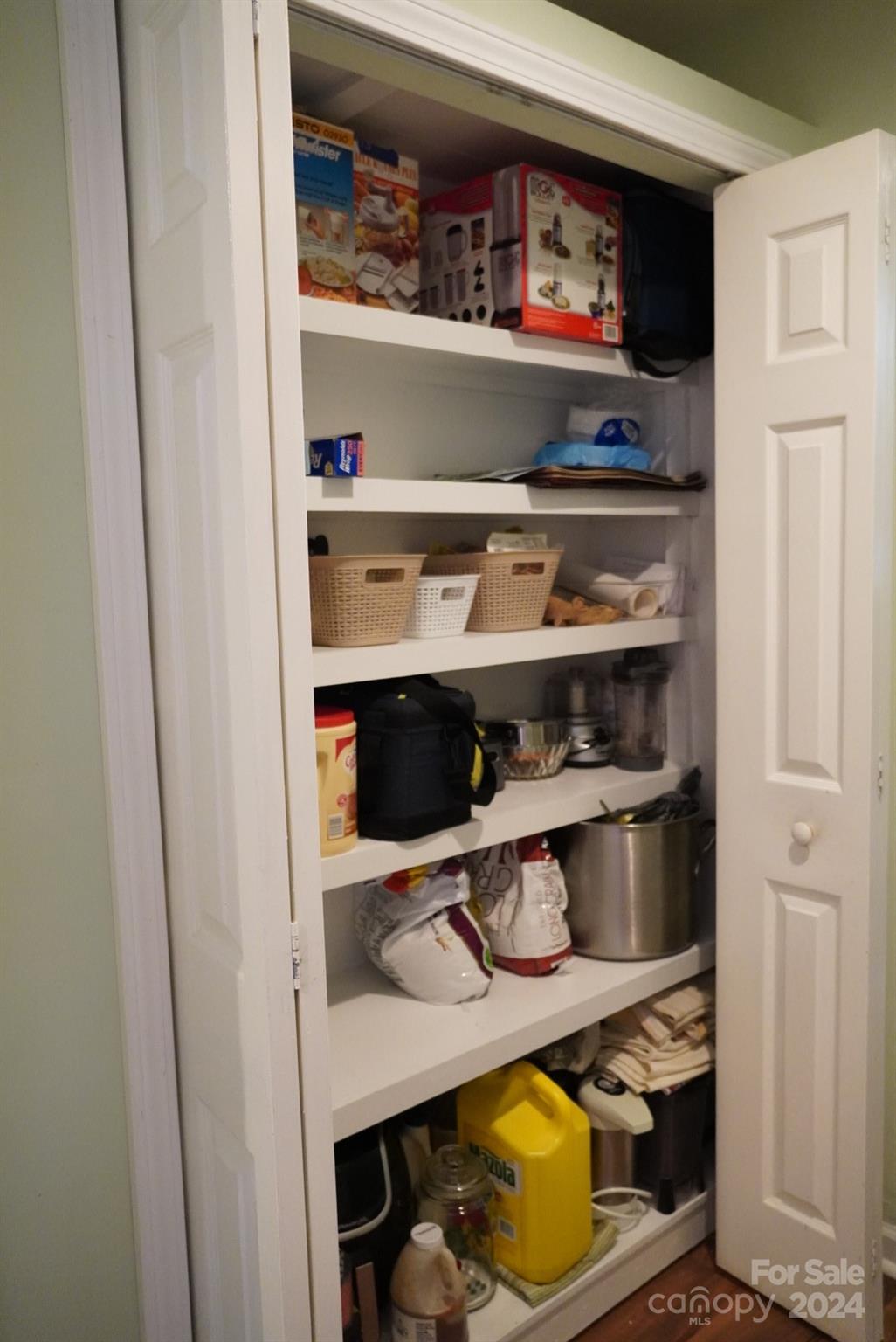 8357 Barncliff Road Charlotte, NC 28227 - Photo 10 of 15 a shelf with books and knick knacks on it