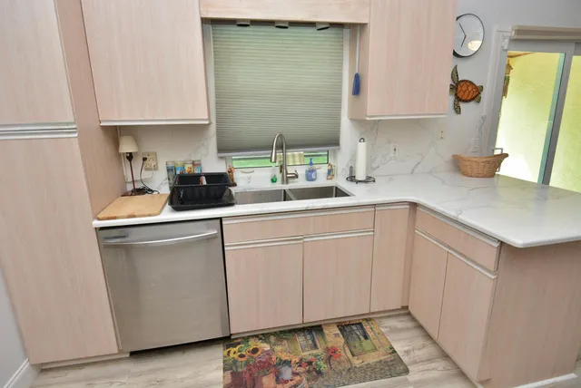 a kitchen with a sink cabinets and appliances