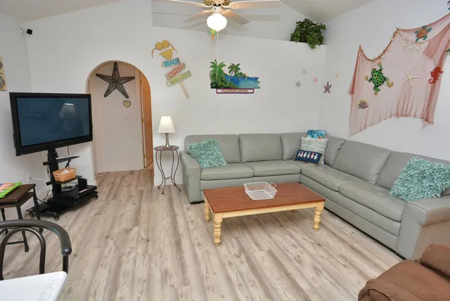 a living room with furniture and a flat screen tv