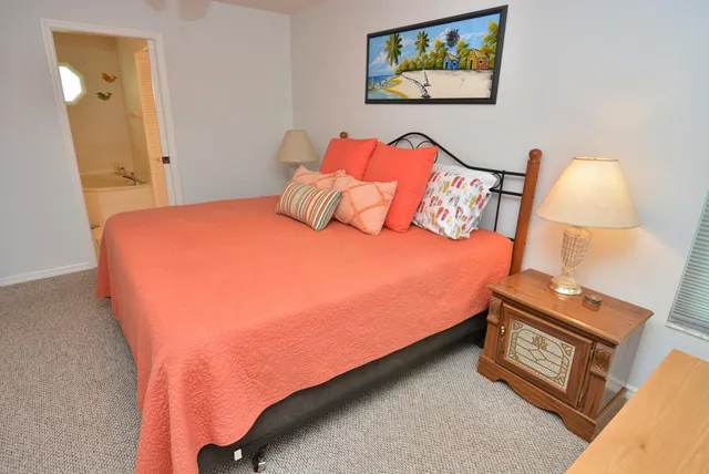 a bedroom with a bed and a painting on the wall