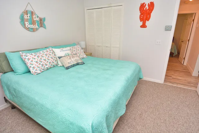 a bedroom with a bed and a painting on the wall