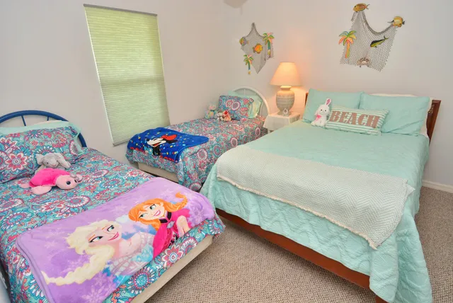 a bedroom with two beds and a table