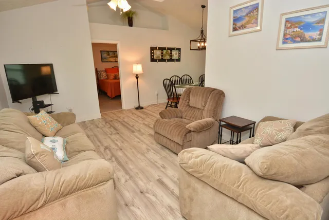 a living room with couches and a flat screen tv