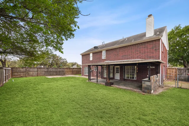 a front view of a house with a yard table and chairs