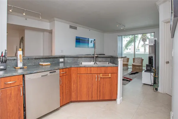 a spacious bathroom with stainless steel appliances granite countertop a sink stove and cabinets
