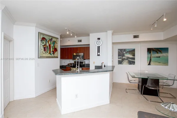 a kitchen with stainless steel appliances granite countertop a sink and a refrigerator