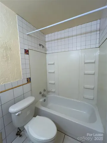 a bathroom with a toilet and shower