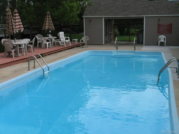 a view of a swimming pool with furniture
