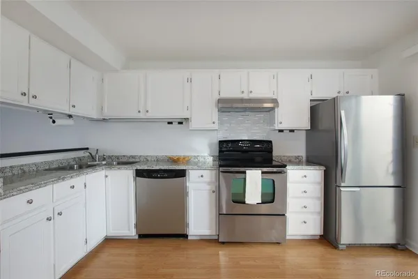 a kitchen with stainless steel appliances granite countertop a stove a refrigerator and a granite counter tops