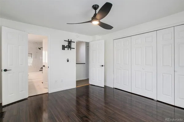 a view of empty room with wooden floor