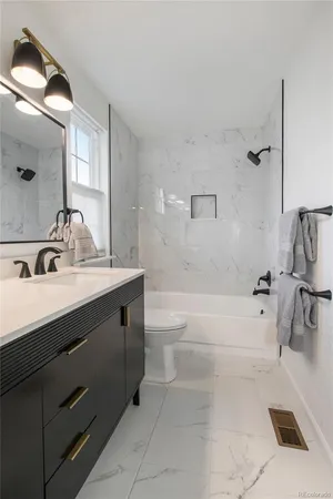 a bathroom with a tub sink and mirror