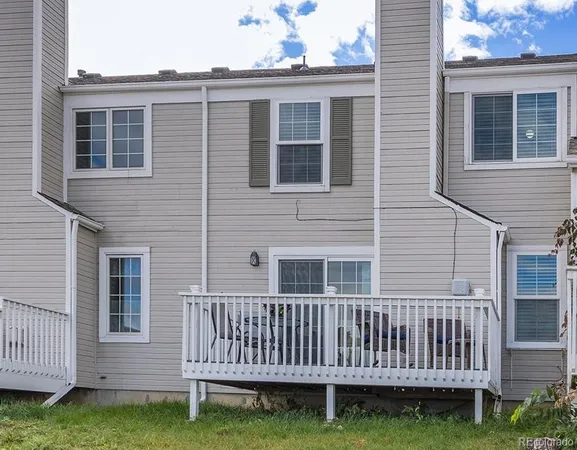 a view of a house with a deck and a yard