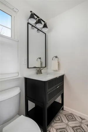 a bathroom with a toilet sink and mirror