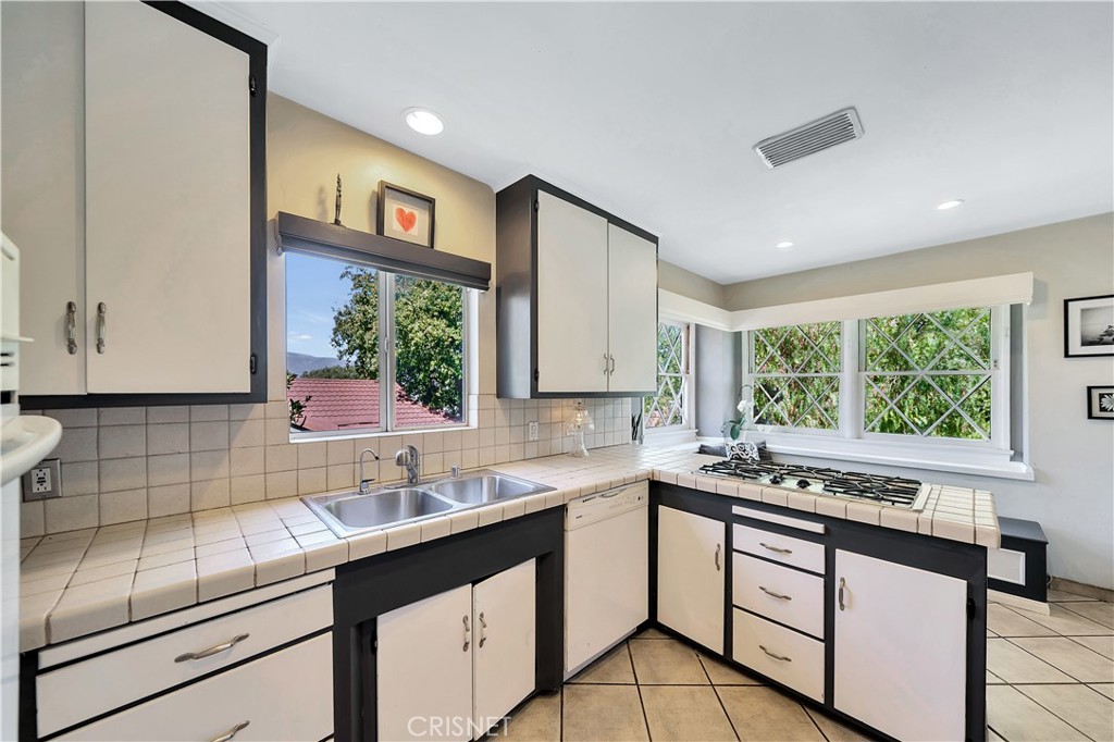 3667 Willowcrest Avenue Studio City, CA 91604 - Photo 12 of 49 a kitchen with a sink appliances cabinets and a window