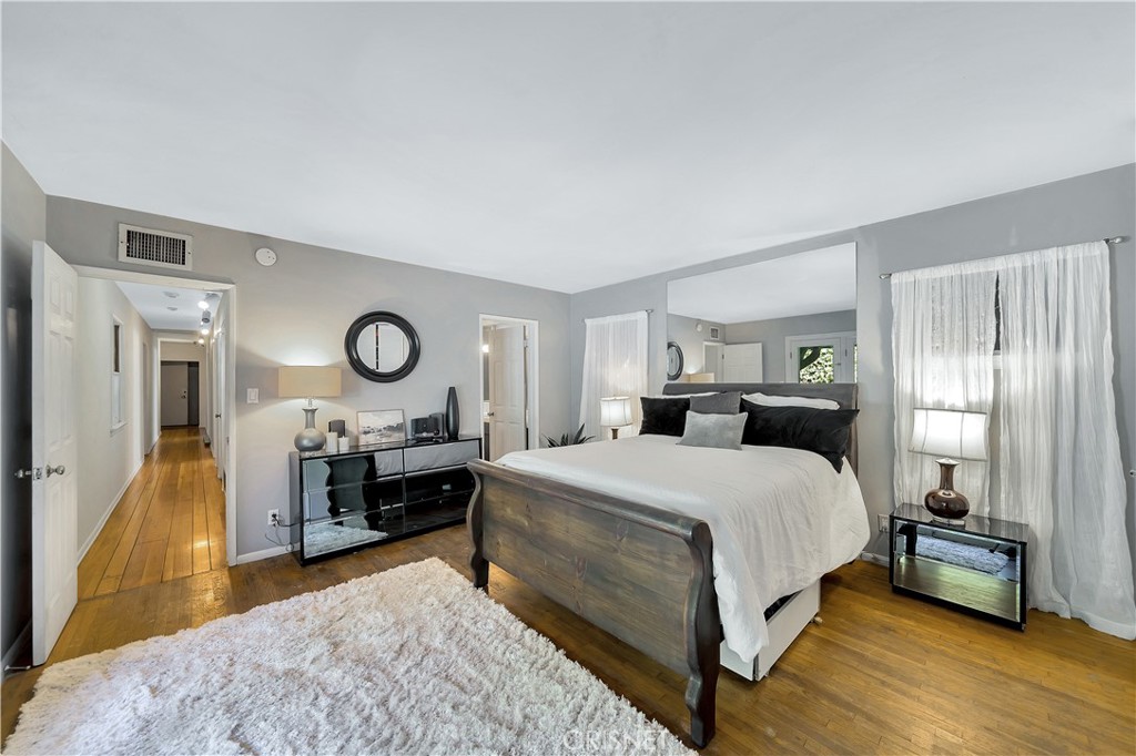 3667 Willowcrest Avenue Studio City, CA 91604 - Photo 20 of 49 a bedroom with a bed and wooden floor