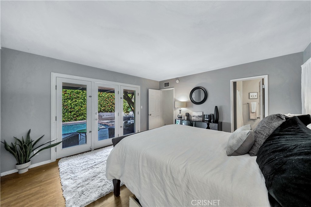 3667 Willowcrest Avenue Studio City, CA 91604 - Photo 22 of 49 a bedroom with a large bed and a large window