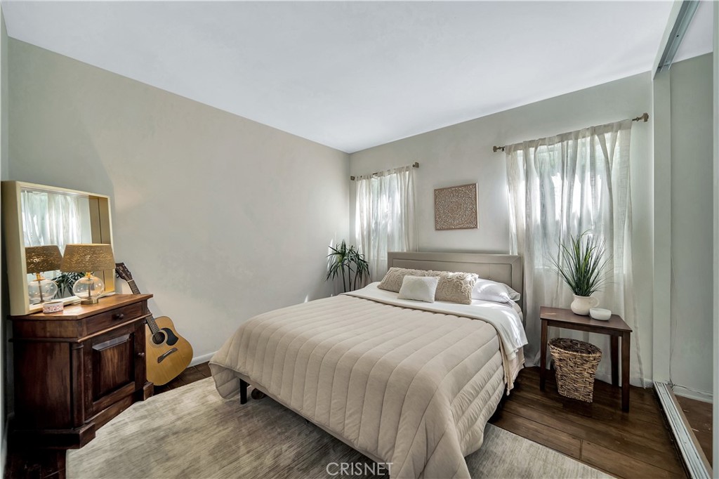 3667 Willowcrest Avenue Studio City, CA 91604 - Photo 24 of 49 a bedroom with a bed and wooden floor
