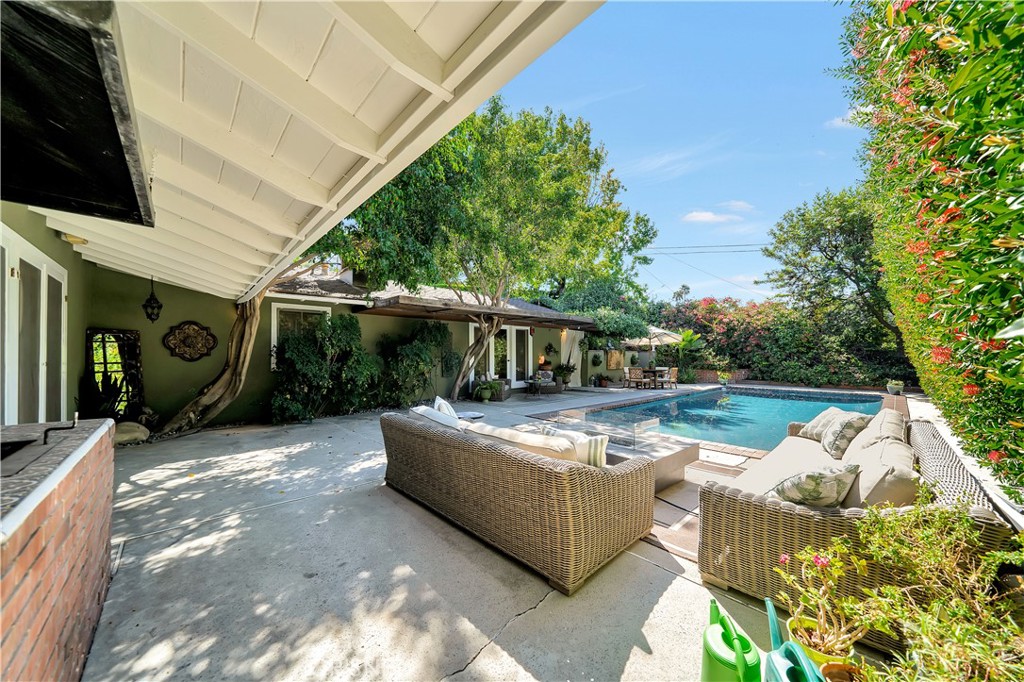 3667 Willowcrest Avenue Studio City, CA 91604 - Photo 33 of 49 a view of a house with backyard tub and couches under an umbrella