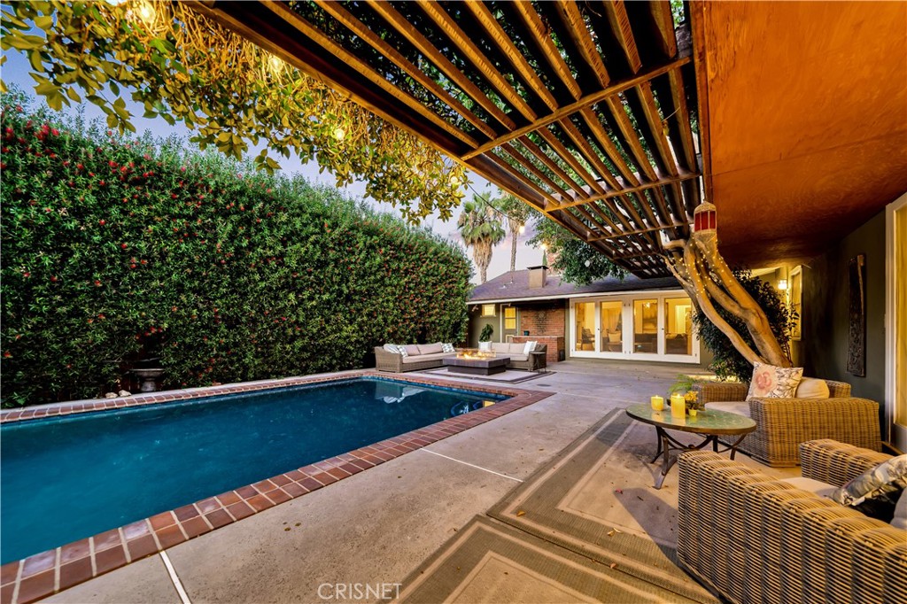 3667 Willowcrest Avenue Studio City, CA 91604 - Photo 34 of 49 a view of a patio with couches table and chairs under an umbrella with a small yard