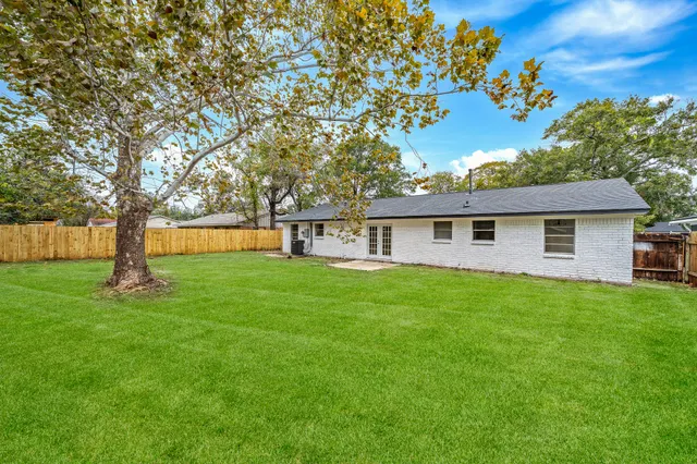 a view of a house with a backyard