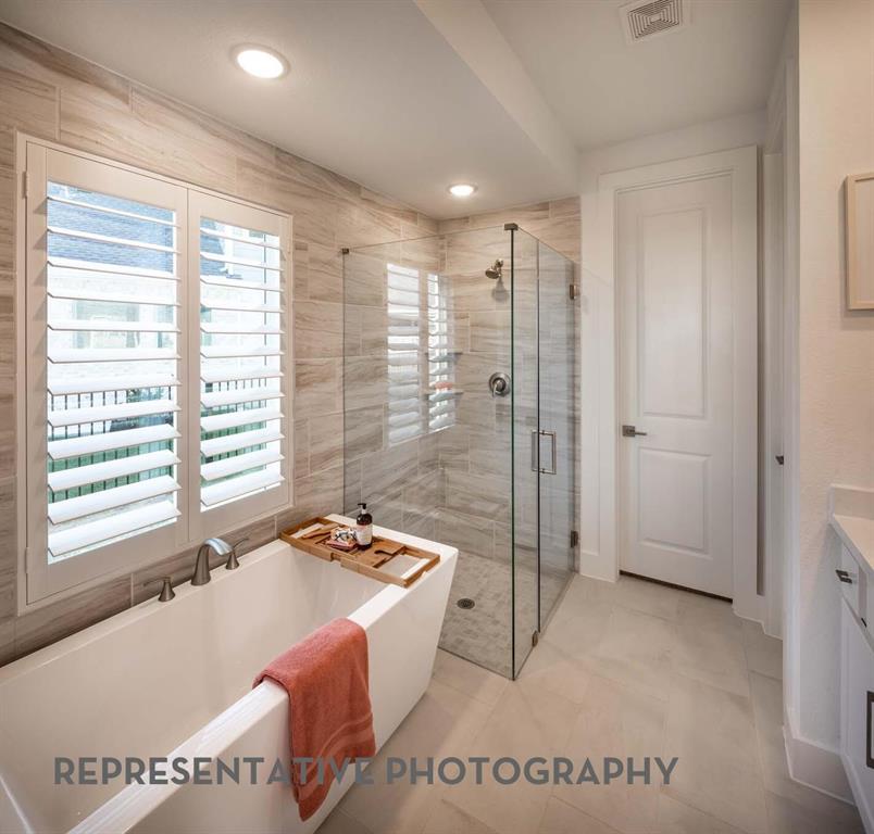 832 Stone Grv Road Lavon, TX 75166 - Photo 7 of 21 a spacious bathroom with a granite countertop tub shower and a sink