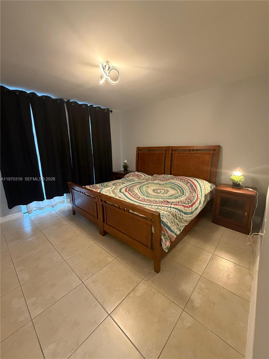 17600 North Bay Road, Unit N907 Sunny Isles Beach, FL 33160 - Photo 11 of 22 a bedroom with a bed and a cabinets