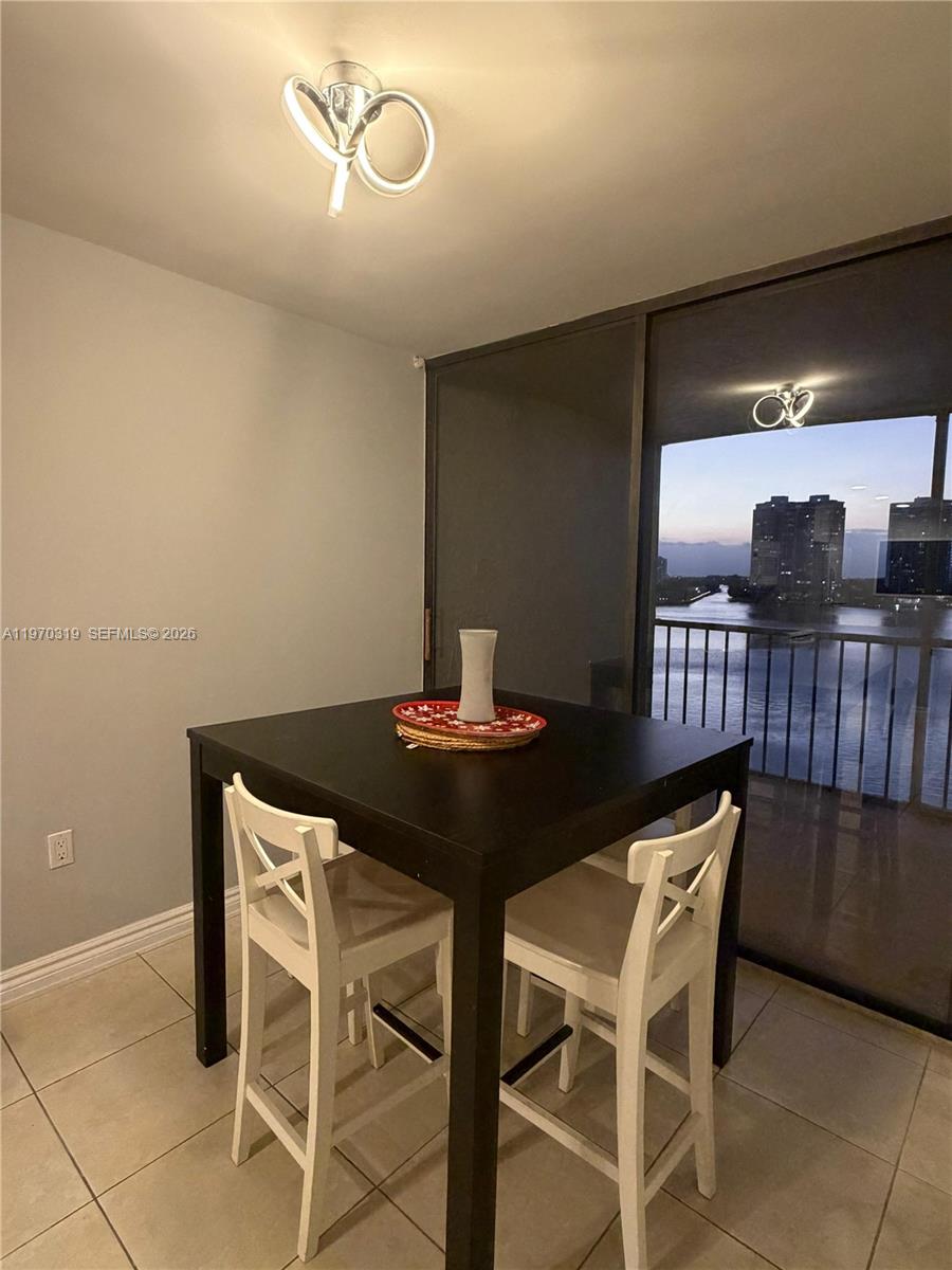 17600 North Bay Road, Unit N907 Sunny Isles Beach, FL 33160 - Photo 13 of 22 a dining room with furniture and chandelier fan