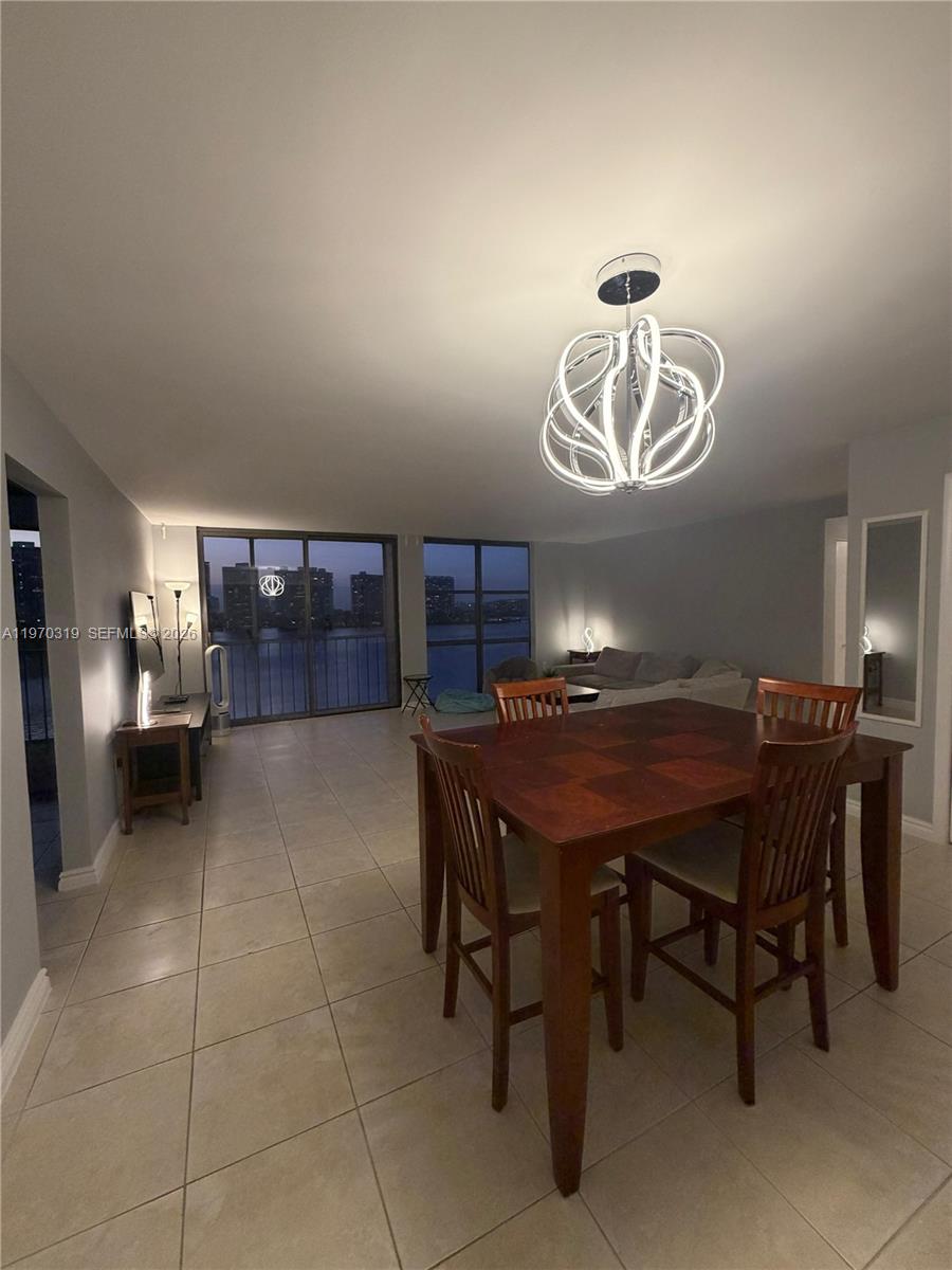 17600 North Bay Road, Unit N907 Sunny Isles Beach, FL 33160 - Photo 15 of 22 a dining room with a table and chairs