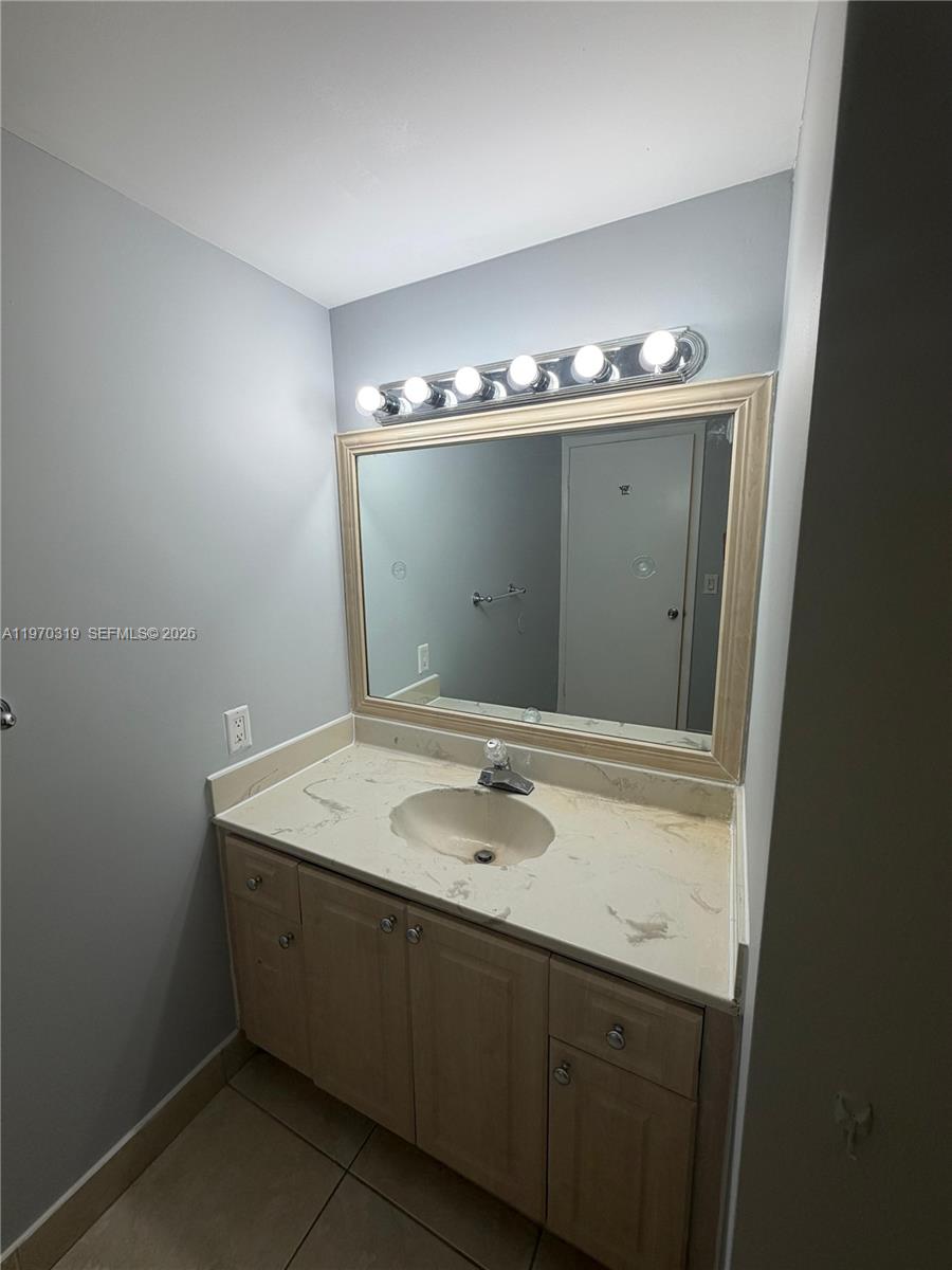 17600 North Bay Road, Unit N907 Sunny Isles Beach, FL 33160 - Photo 18 of 22 a bathroom with a sink and a mirror