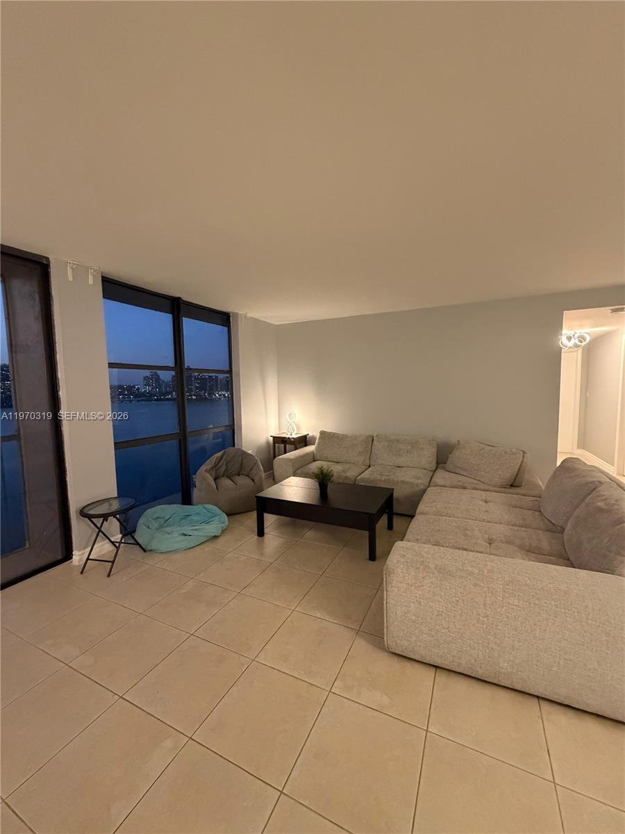 17600 North Bay Road, Unit N907 Sunny Isles Beach, FL 33160 - Photo 5 of 22 a living room with couches and a fireplace