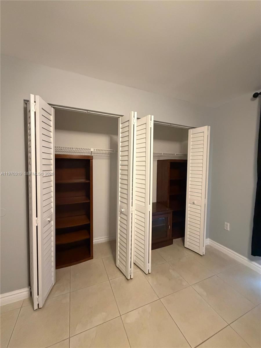 17600 North Bay Road, Unit N907 Sunny Isles Beach, FL 33160 - Photo 9 of 22 a view of room with closet and stairs