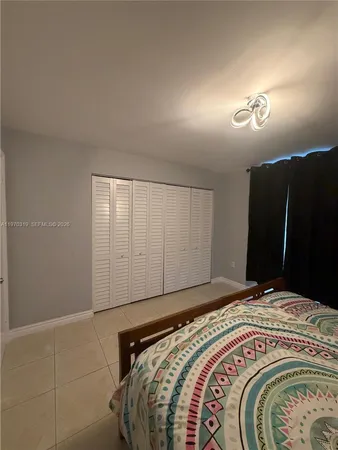 a bedroom with a bed and a mirror