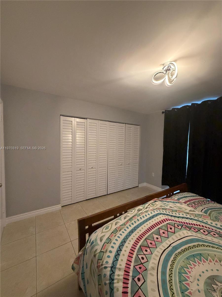 17600 North Bay Road, Unit N907 Sunny Isles Beach, FL 33160 - Photo 10 of 22 a bedroom with a bed and a mirror