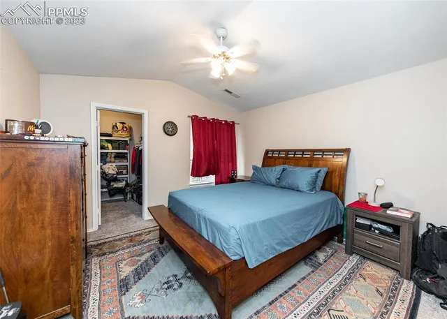 a bedroom with bed and dresser
