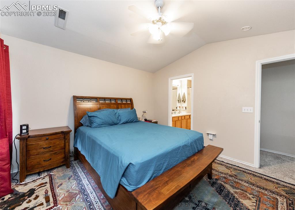 3847 Riviera Grove, Unit 203 Colorado Springs, CO 80922 - Photo 18 of 32 a bedroom with a bed and wooden floor