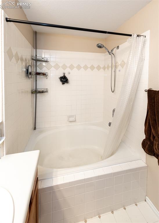 3847 Riviera Grove, Unit 203 Colorado Springs, CO 80922 - Photo 20 of 32 a bathroom with a shower and a bath tub