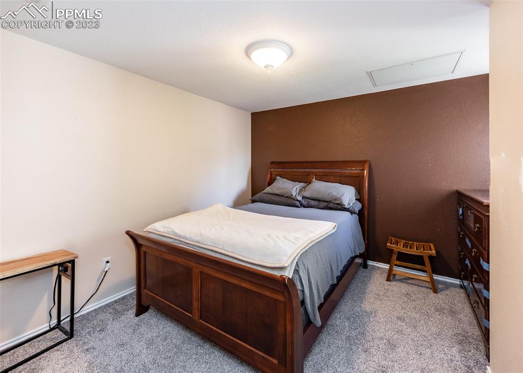 3847 Riviera Grove, Unit 203 Colorado Springs, CO 80922 - Photo 21 of 32 a bedroom with a bed and a tv in it