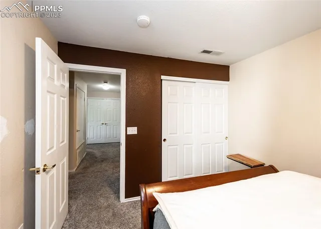 a bedroom with a bed and a table