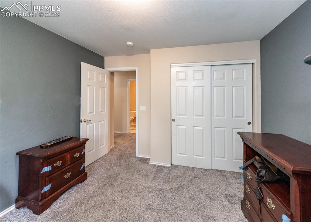 3847 Riviera Grove, Unit 203 Colorado Springs, CO 80922 - Photo 23 of 32 a view of room with furniture and wooden floor