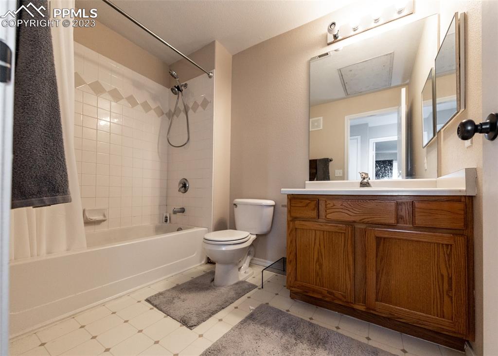 3847 Riviera Grove, Unit 203 Colorado Springs, CO 80922 - Photo 24 of 32 a bathroom with a granite countertop sink toilet and shower