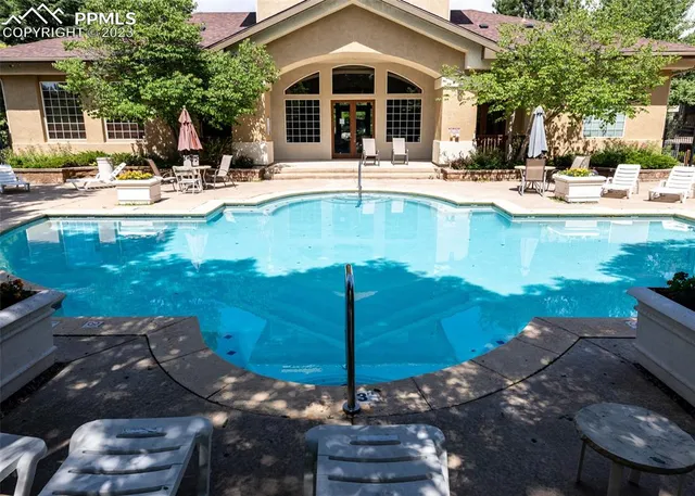 a view of a house with backyard and sitting area