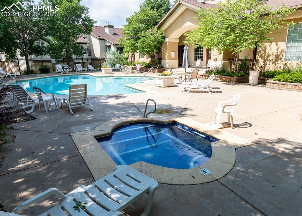 3847 Riviera Grove, Unit 203 Colorado Springs, CO 80922 - Photo 30 of 32 a view of a swimming pool with a patio